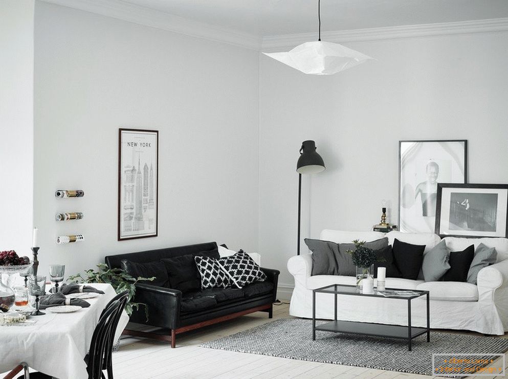 Obývací pokoj je bílý s černou pohovkou
