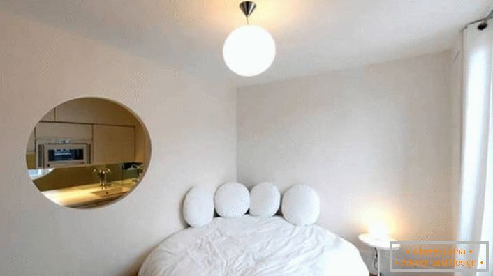 Prázdnota ve stěně oválného tvaru činí malý byt luxusním ateliérem.