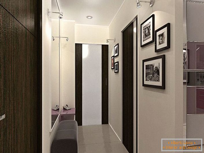 Designové řešení pro úzké chodby. Dekorace v kontrastní bílé a tmavě hnědé barvě nejen vypadá stylově, ale i vizuálně dělá místnost více.