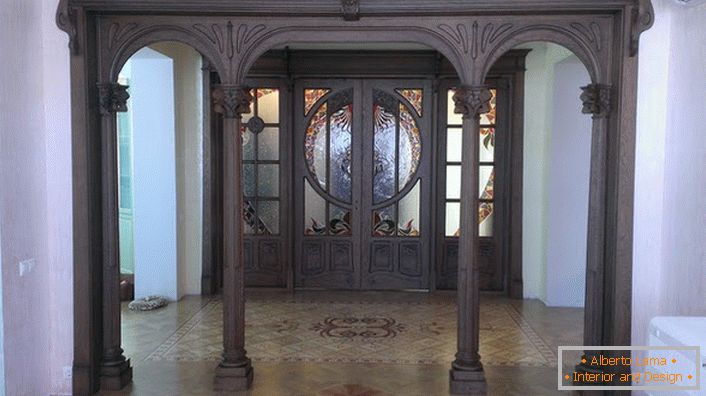 Vstupní dveře v secesním stylu jsou vyrobeny z tmavého dřeva drahého dřeva. Hala s takovými dveřmi vypadá vážně a pompézně. 