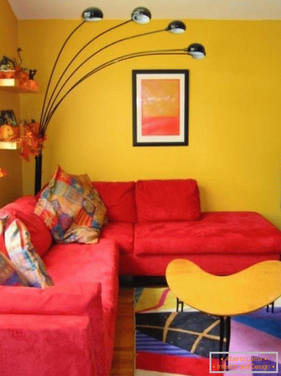 Červená pohovka v žlutém obývacím pokoji