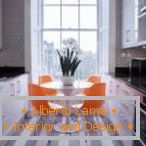 Oranžová židle v šedém interiéru kuchyně