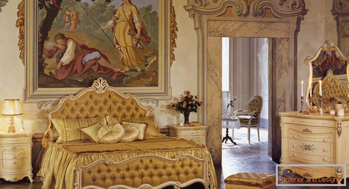 Ložnice v barokním stylu ve zlatých barvách. Stěna na hlavě postele je zdobena obrovským starožitným obrazem.